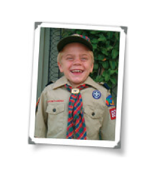 Bryce in boy scout uniform smiling